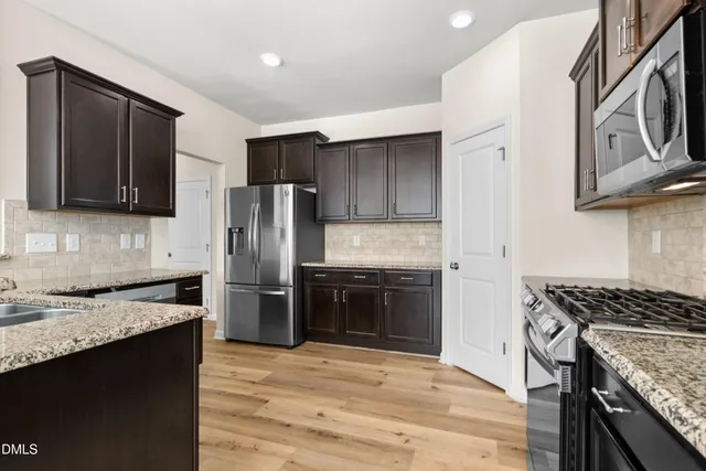 a view of a room with wooden floor and windows