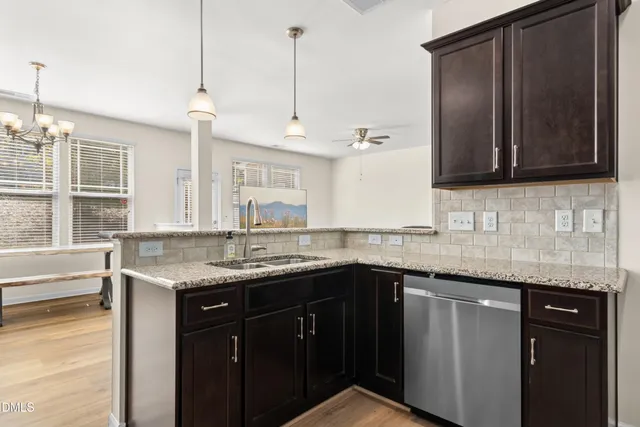 a kitchen with granite countertop stainless steel appliances and sink