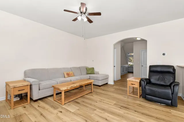 a living room with furniture and a large window with wooden floor