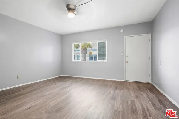 wooden floor in an empty room with a window