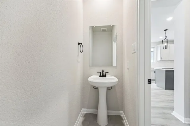 a bathroom with a sink and mirror