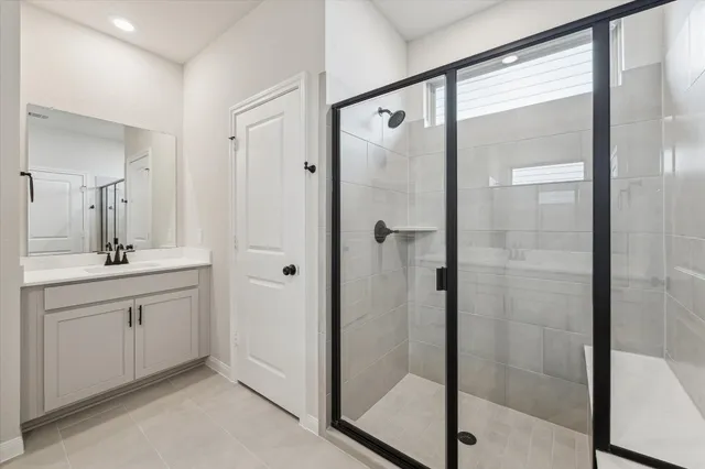 a bathroom with a shower sink and mirror
