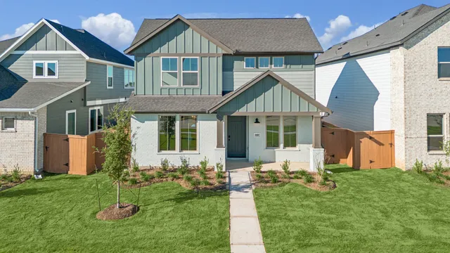 a front view of a house with a yard and porch