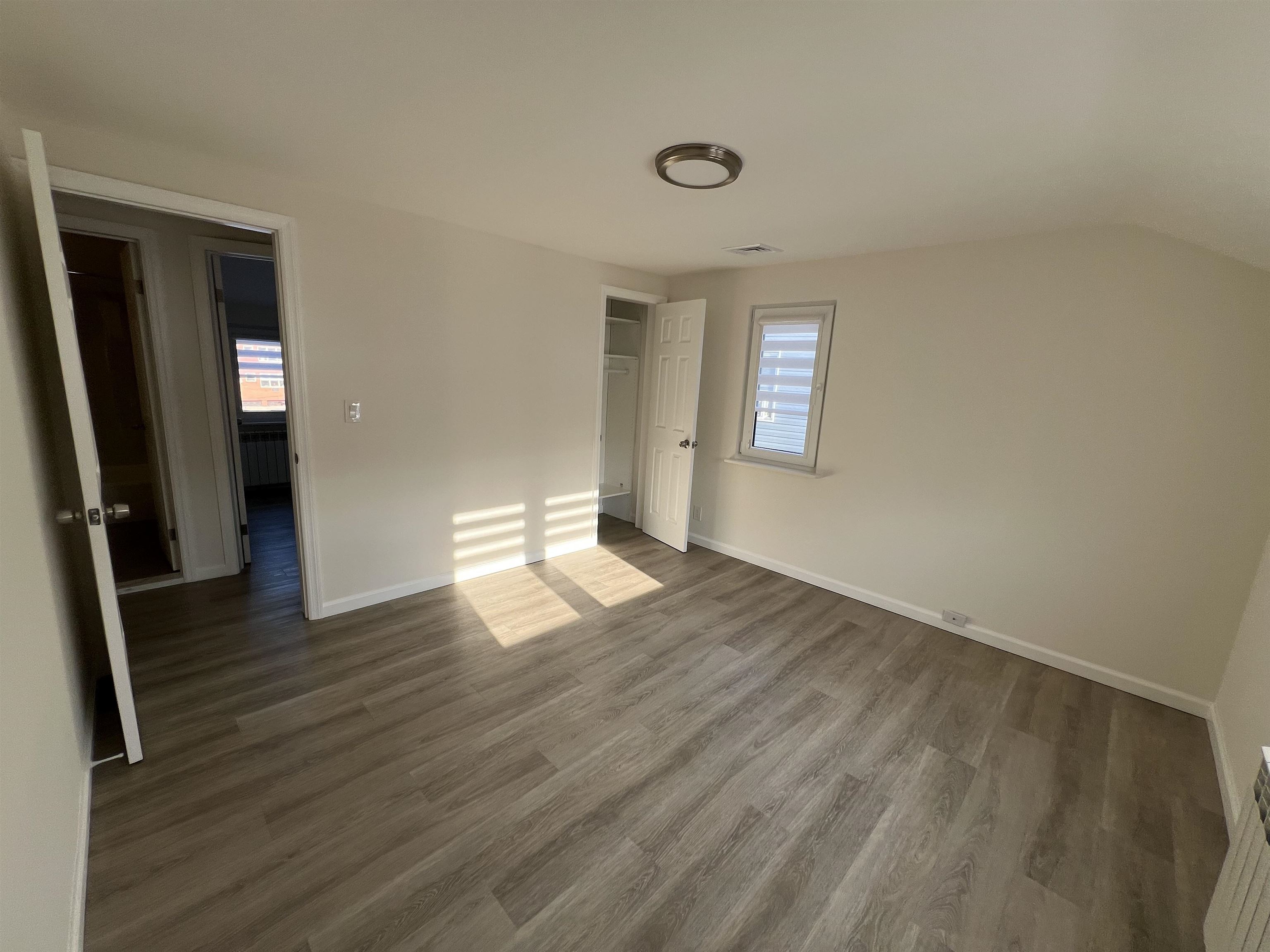 35 MacArthur Avenue, Unit 2 Hasbrouck Heights, NJ 07604 - Photo 12 of 14 a view of empty room with wooden floor and fan