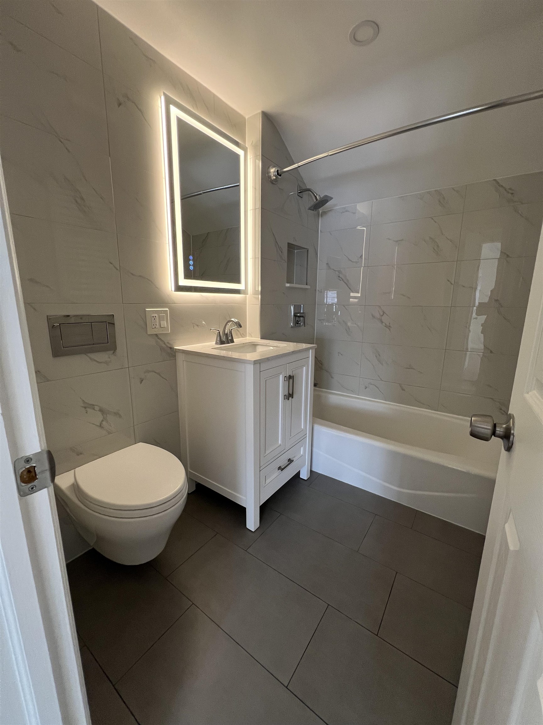 35 MacArthur Avenue, Unit 2 Hasbrouck Heights, NJ 07604 - Photo 10 of 14 a bathroom with a sink a toilet and shower