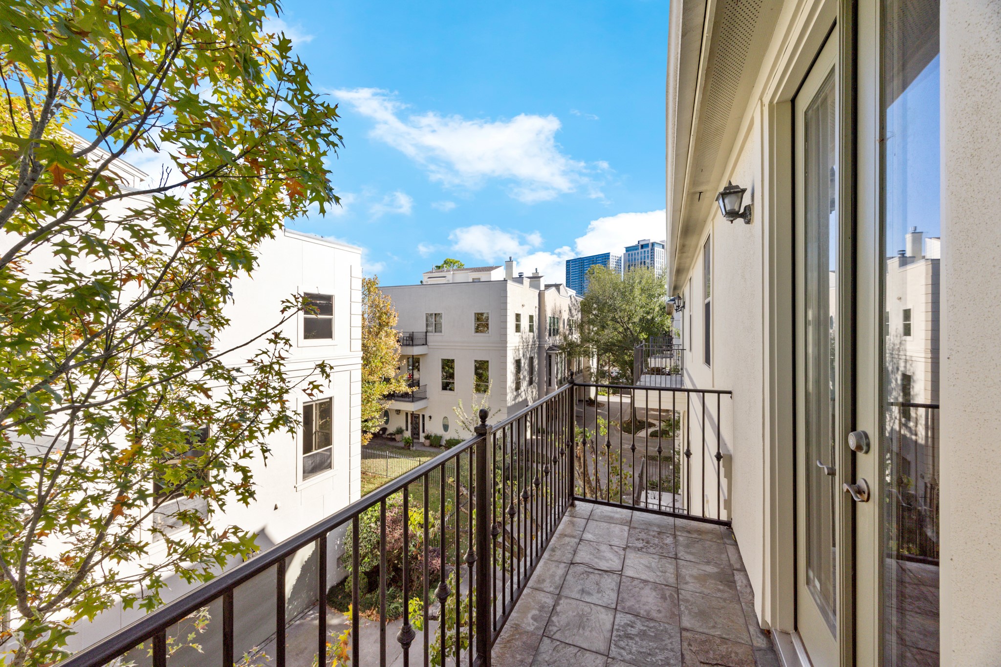 This balcony, located just off the kitchen offers a charming, tree-lined view with glimpses of the Houston skyline beyond. The elevated vantage point highlights the unique blend of residential privacy and city energy that defines the area. Perfect for morning coffee or evening unwinding, this outdoor space captures the character of the neighborhood and showcases just how special this location truly is.
