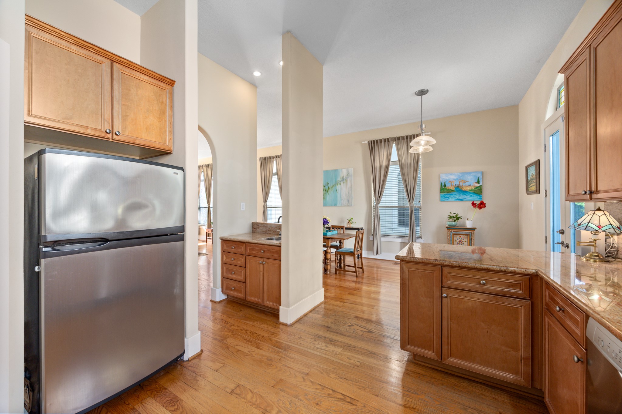 2611 Commonwealth Street Houston, TX 77006 - Photo 19 of 31 This kitchen features a warm, inviting design with rich wood cabinetry, granite countertops, and stainless steel appliances that blend style with everyday functionality.