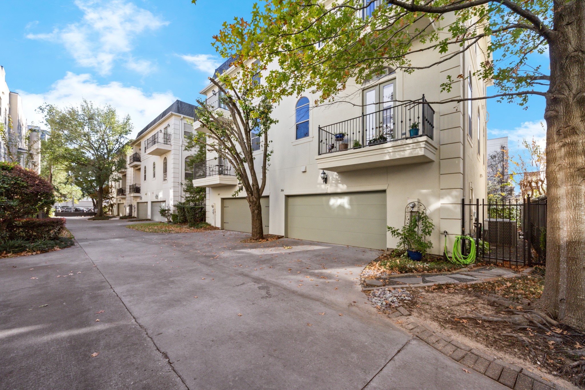 2611 Commonwealth Street Houston, TX 77006 - Photo 30 of 31 Spacious two-car garage with additional storage provides everyday convenience and flexibility. Two private, secure gates offer easy access to the property and courtyard. Set among mature trees and a beautifully maintained streetscape, this area delivers an ideal blend of privacy, accessibility, and effortless living.