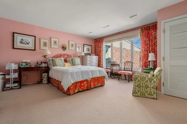 a bedroom with bed and a large window