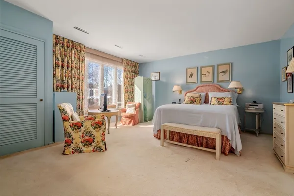 a bedroom with bed and a large window