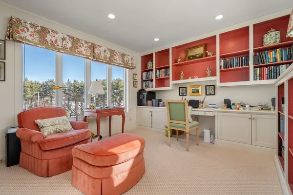 a living room with furniture a rug and a large window