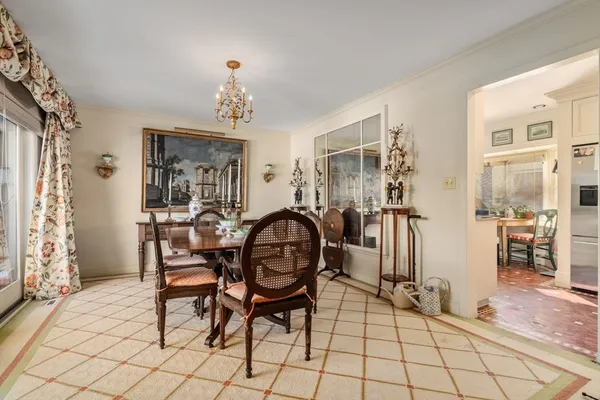 a dining room with furniture and chandelier