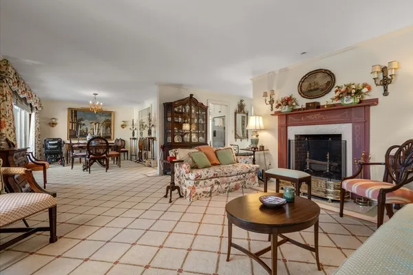 a living room with furniture a table and a fireplace