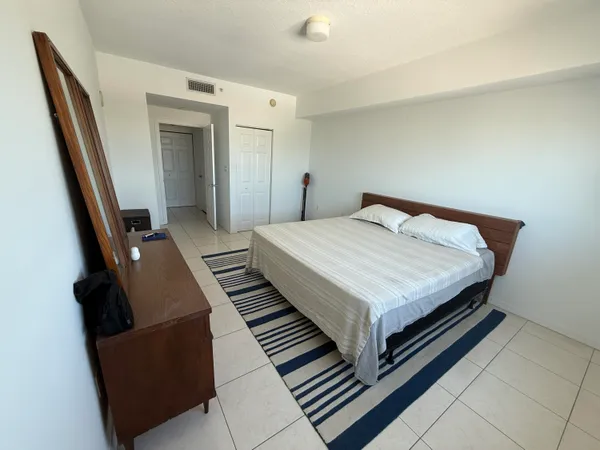 a bedroom with a bed and a dresser