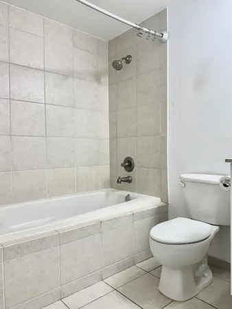 a bathroom with a sink a toilet a mirror and shower