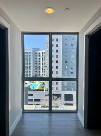a view of a room with wooden floor and windows