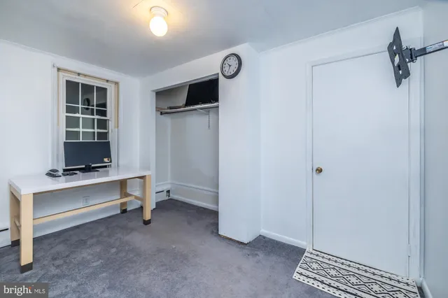 a view of workspace with flat screen tv cabinet and window