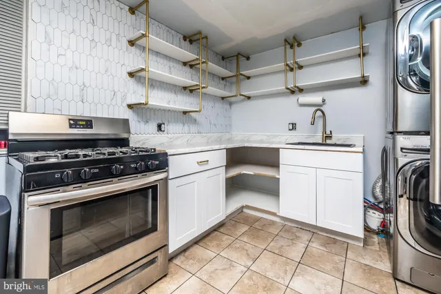 a kitchen with cabinets a washer and dryer