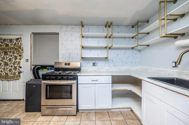 a kitchen with cabinets appliances and a sink