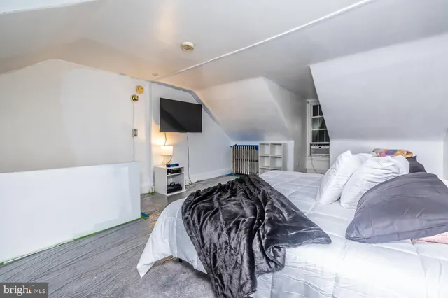 a bed room with a bed and a television