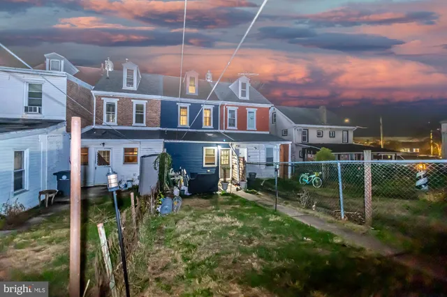 a view of a brick building next to a yard