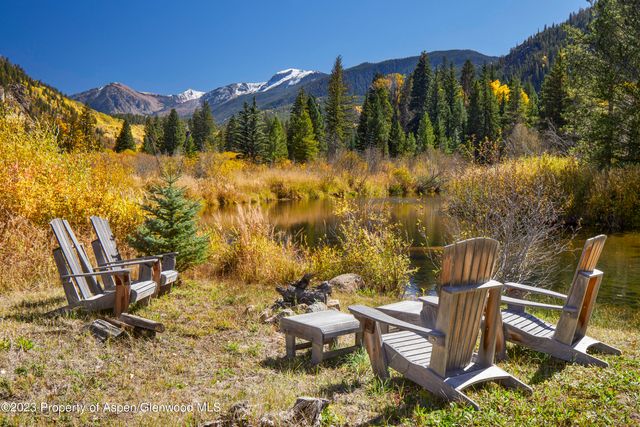 a view of a chairs and table in patio