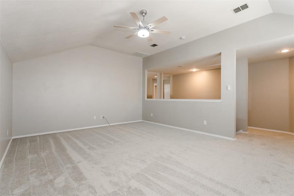 203 Arabian Road Waxahachie, TX 75165 - Photo 16 of 24 Spacious room featuring vaulted ceilings, light gray carpeting, and a contemporary ceiling fan
