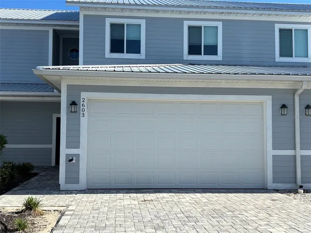 a view of a house with wooden fence