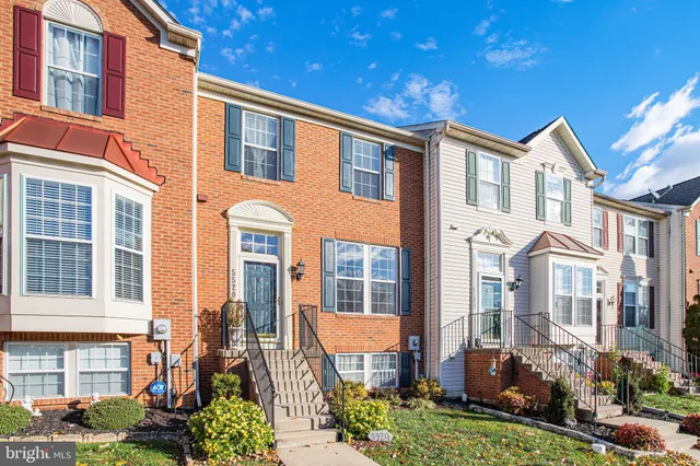 a view of living room with furniture and wooden floor