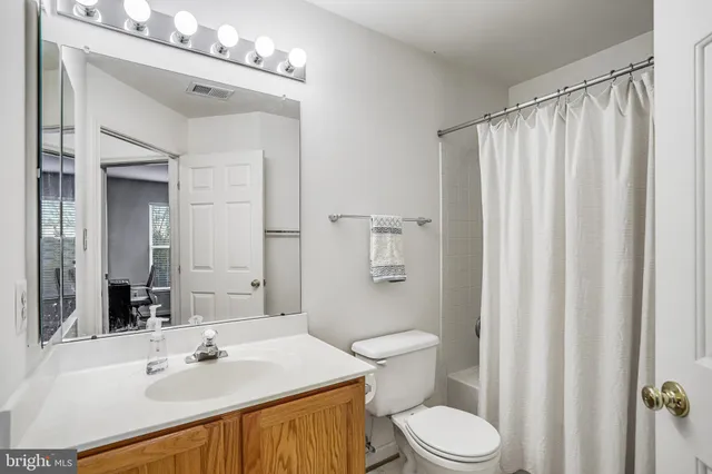 a view of a room with gym equipment and wooden floor