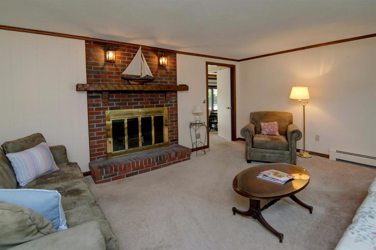 67 Lumbert Mill Road Centerville, MA 02632 - Photo 4 of 18 a living room with furniture and a fireplace