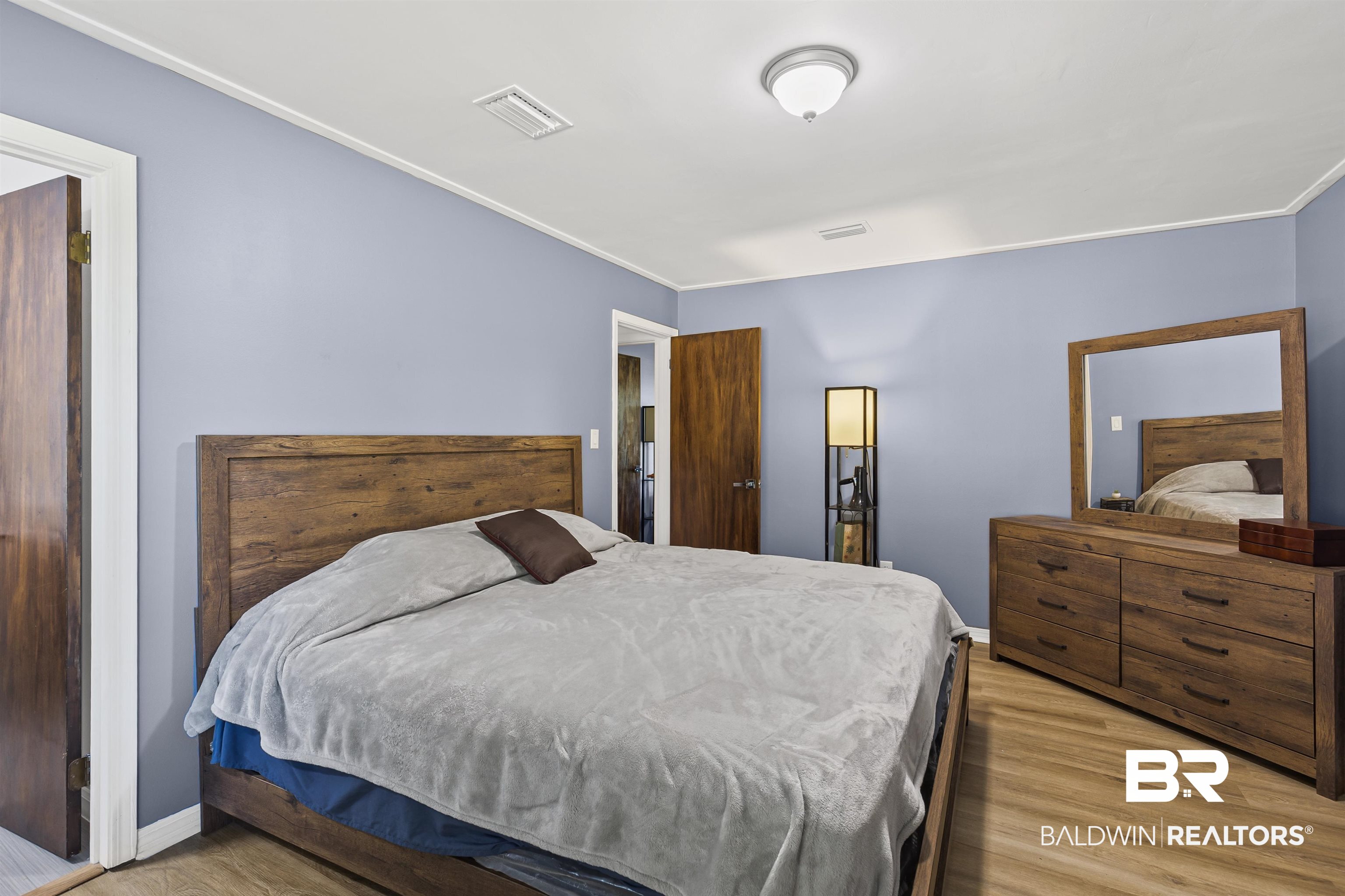 8911 Owassa Road Evergreen, AL 36401 - Photo 13 of 24 Bedroom with light wood finished floors and crown molding