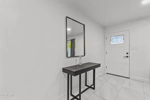 a view of a livingroom with a table and chair