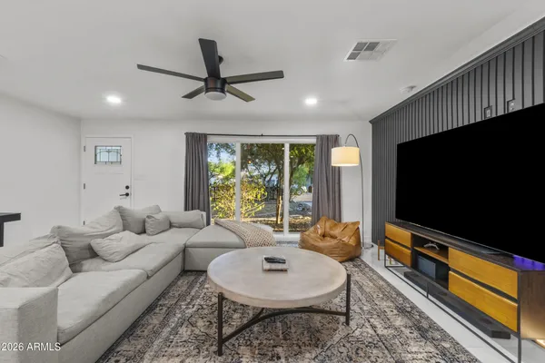 a living room with furniture and a flat screen tv