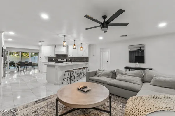a living room with furniture and kitchen view