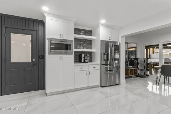a kitchen with stainless steel appliances granite countertop a refrigerator and a stove top oven