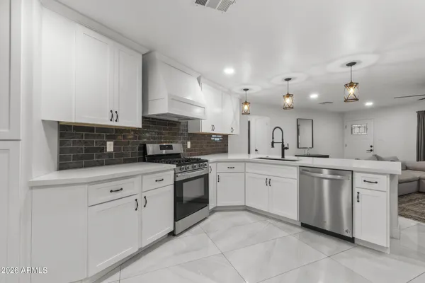 a kitchen with stainless steel appliances granite countertop a sink and cabinets
