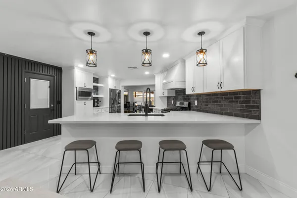 a kitchen with stainless steel appliances a sink and cabinets