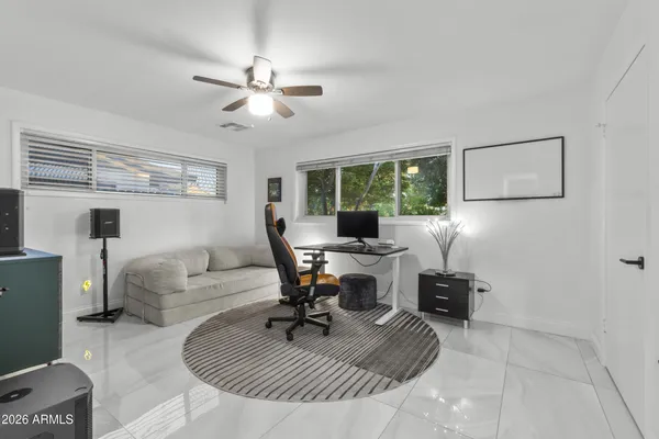 a view of a workspace with furniture and a window