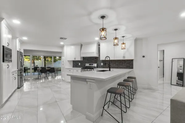 a kitchen with stainless steel appliances kitchen island granite countertop a sink and cabinets