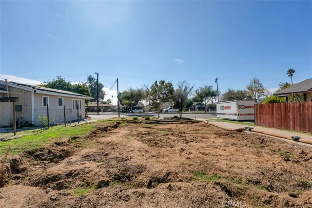 a view of a backyard with large trees