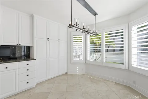 a livingroom with window cabinet and flat screen tv