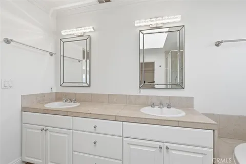 a bathroom with a sink double vanity and a mirror