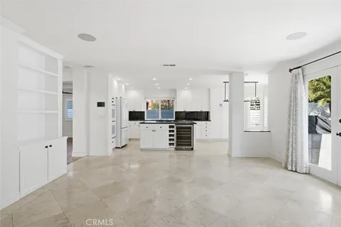 a view of kitchen with refrigerator and window