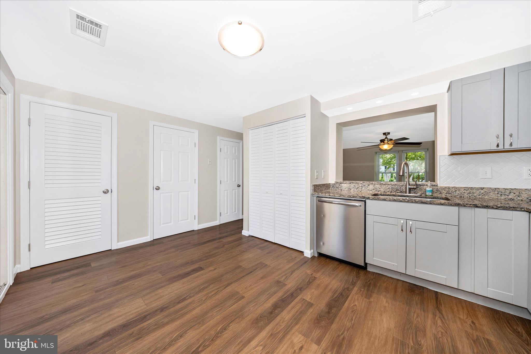 1369 David Lane Frederick, MD 21703 - Photo 18 of 53 a kitchen with granite countertop a sink cabinets and wooden floor