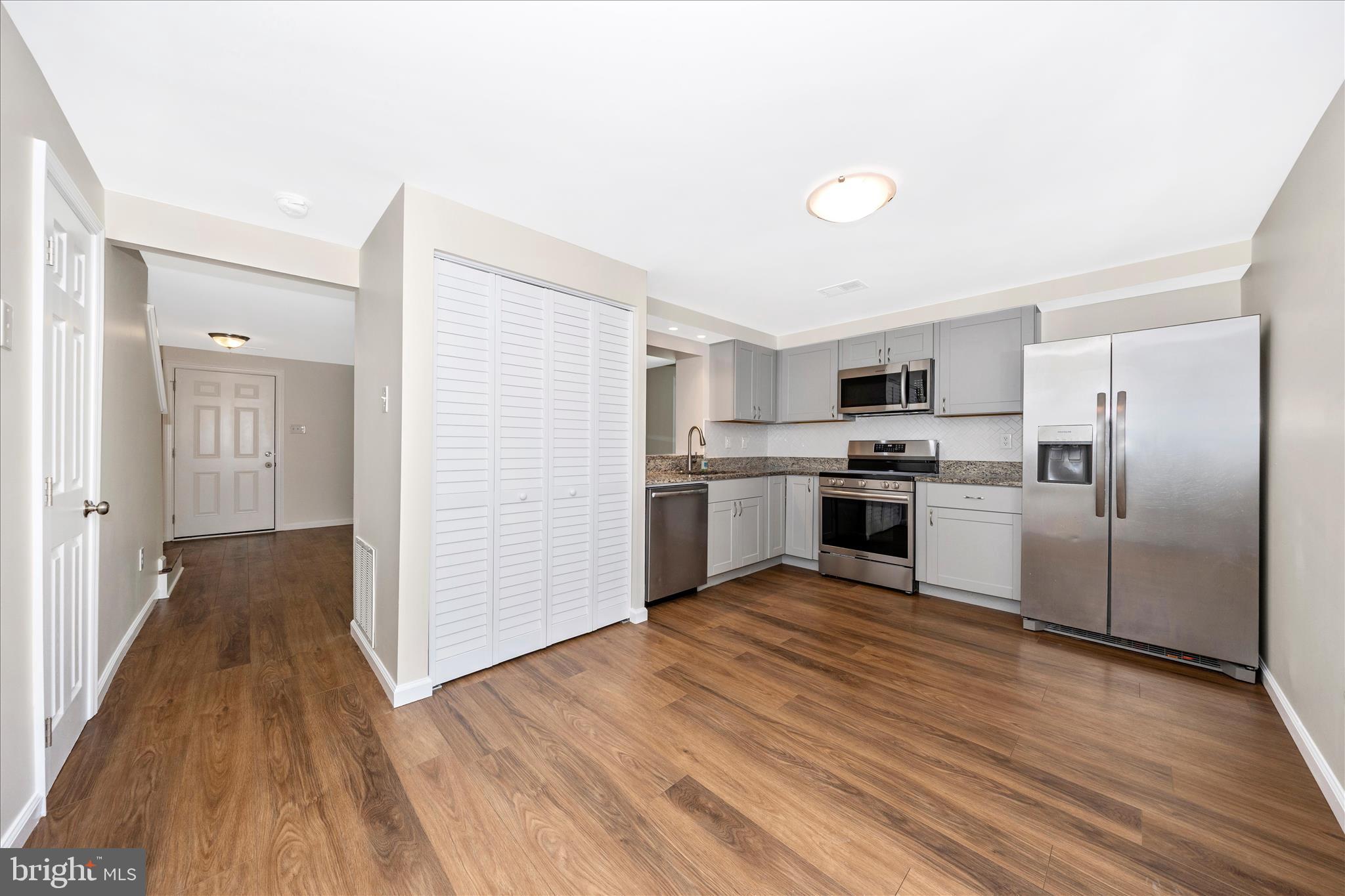 1369 David Lane Frederick, MD 21703 - Photo 19 of 53 a kitchen with white cabinets and stainless steel appliances