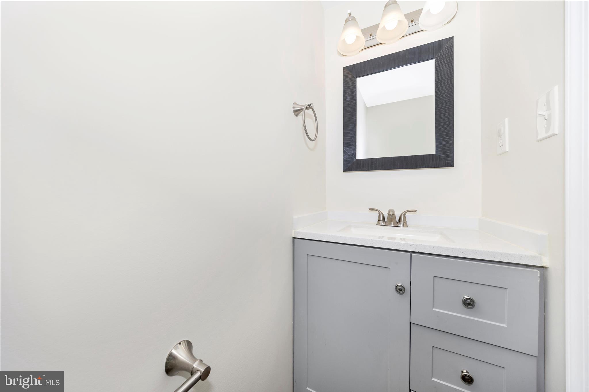 1369 David Lane Frederick, MD 21703 - Photo 4 of 53 a bathroom with a toilet sink vanity and mirror