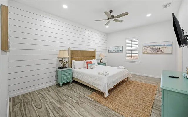 a bedroom with a bed and a ceiling fan