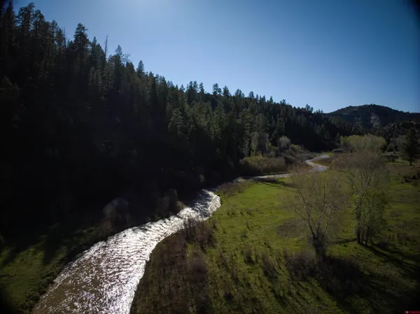 a view of a dry yard with mountains in the background