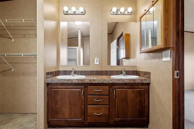 a view of an empty room with a chandelier fan